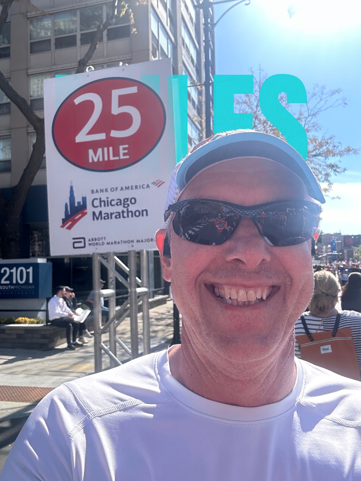 Brent W. Peterson at the 25 mile marker of the Chicago Marathon, MILES lettering behind him